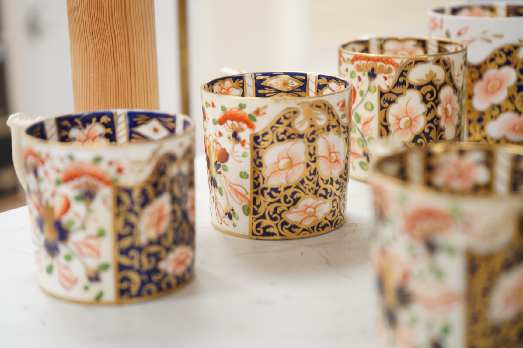A collection of late 18th/19th century English and French porcelain coffee cans, tea cups and vases, some in Imari pattern
